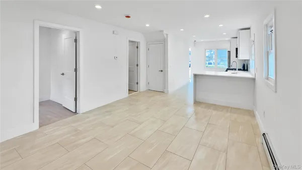 a view of an empty room with kitchen