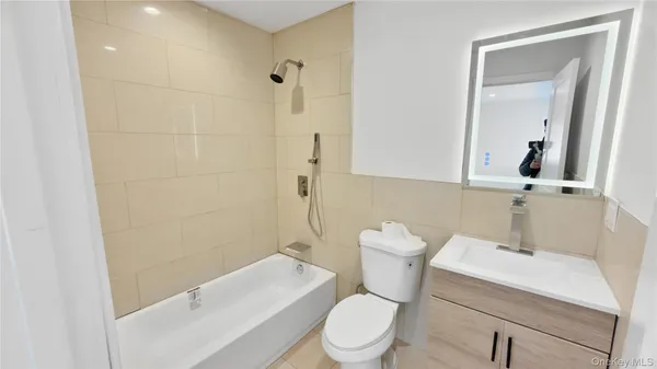 a white toilet sitting next to a bathroom sink