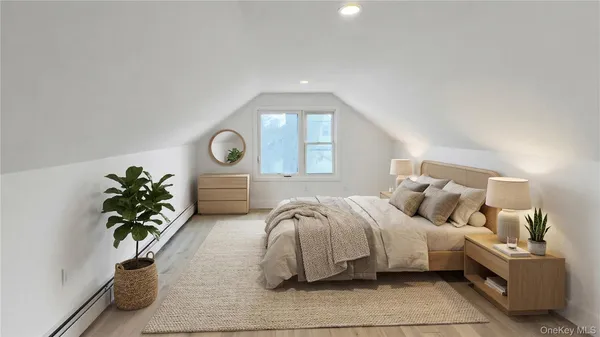 a bedroom with bed and a potted plant