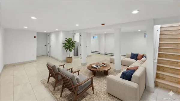 a living room with furniture and a potted plant