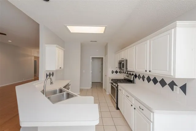 a kitchen with a sink and a stove top oven