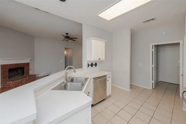 a kitchen with a stove a sink and a microwave