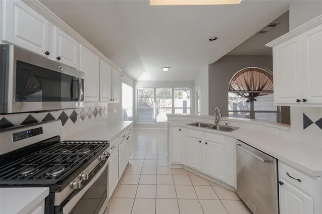a view of empty room with window and ceiling fan