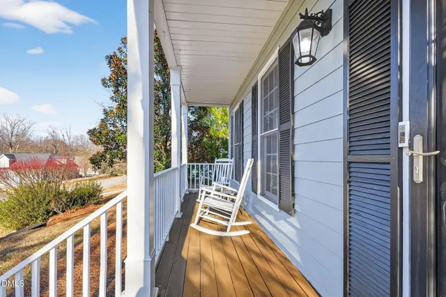 a living room with furniture a fireplace and a large window