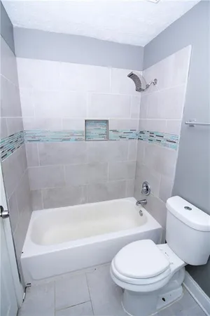 a white bath tub sitting next to a white toilet