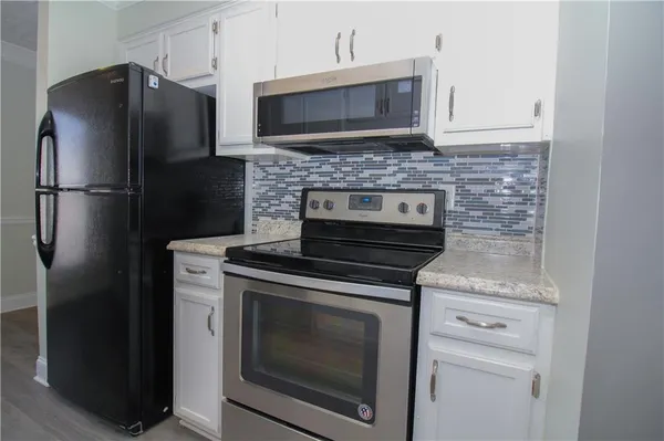 a kitchen with stainless steel appliances wooden cabinets and a stove