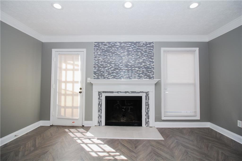 2340 Beaver Ruin Road, Unit UN7 Norcross, GA 30071 - Photo 9 of 20 a living room with a fireplace and a table