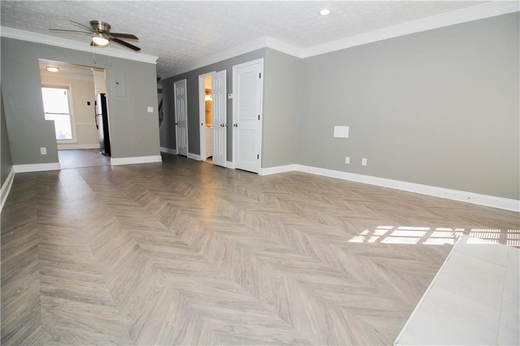 2340 Beaver Ruin Road, Unit UN7 Norcross, GA 30071 - Photo 10 of 20 a view of livingroom with hardwood floor and ceiling fan