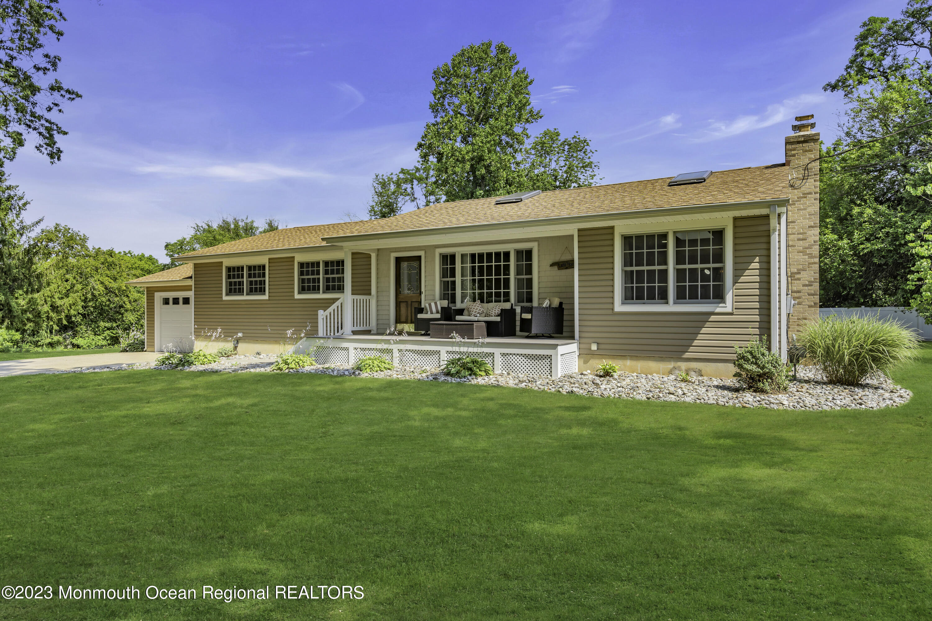 a front view of house with yard and outdoor seating