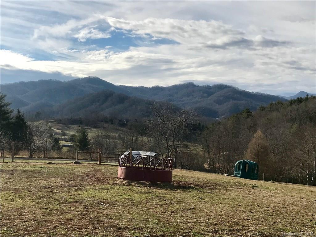 3760 Hyder Mountain Road Clyde, NC 28721 - Photo 1 of 14 a view of a lake with mountain