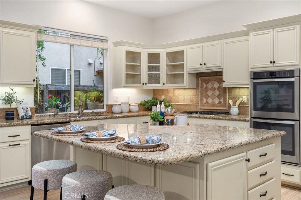 608 Inverlochy Drive Fallbrook, CA 92028 - Photo 15 of 52 a kitchen with stainless steel appliances granite countertop a stove and cabinets