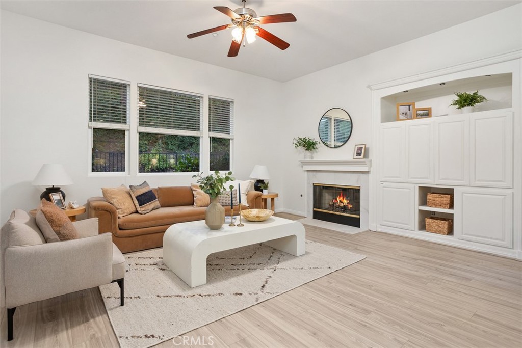 608 Inverlochy Drive Fallbrook, CA 92028 - Photo 22 of 52 a living room with furniture a fireplace and a large window