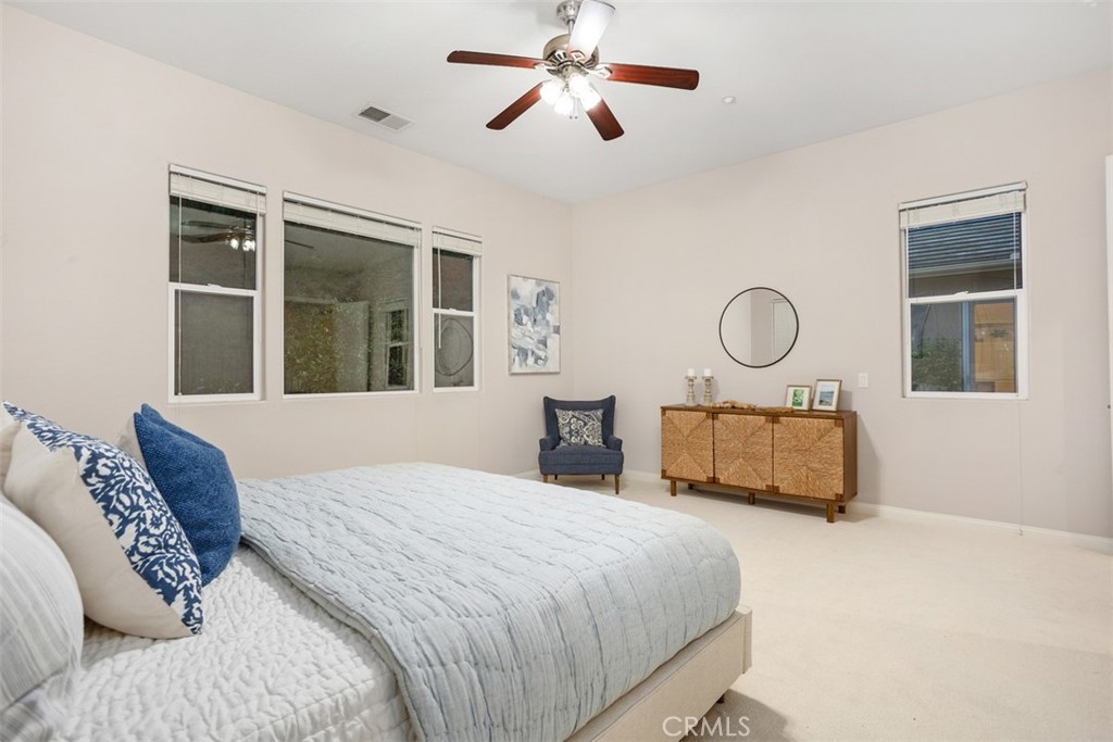 608 Inverlochy Drive Fallbrook, CA 92028 - Photo 24 of 52 a bedroom with a large bed and a chandelier