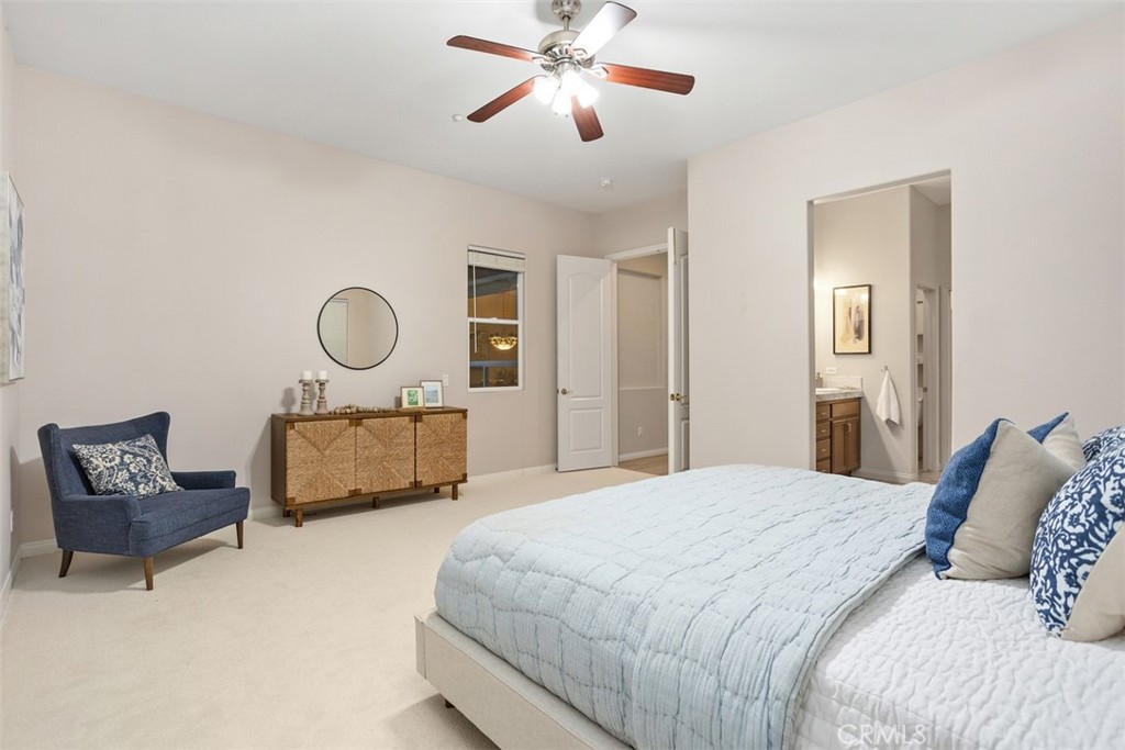 608 Inverlochy Drive Fallbrook, CA 92028 - Photo 25 of 52 a bedroom with a bed and a chandelier