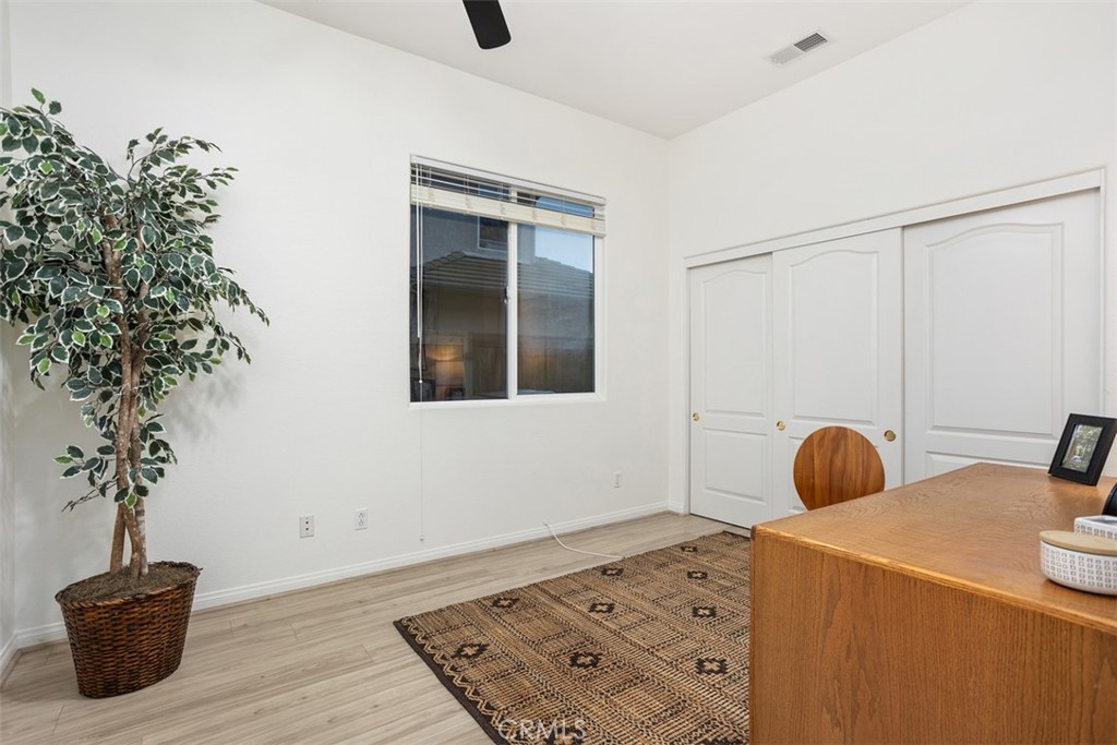 608 Inverlochy Drive Fallbrook, CA 92028 - Photo 31 of 52 a bedroom with a bed and a potted plant