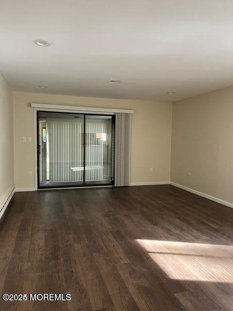 222 Medford Court, Unit E Manalapan, NJ 07726 - Photo 4 of 9 a view of an empty room with wooden floor and a window