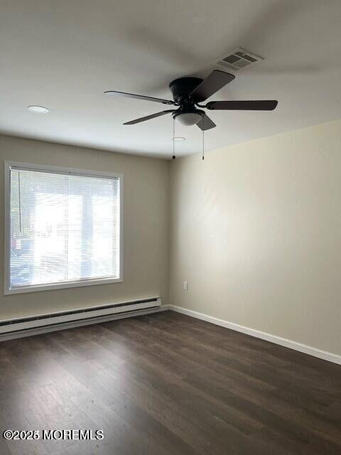 222 Medford Court, Unit E Manalapan, NJ 07726 - Photo 5 of 9 an empty room with wooden floor and windows