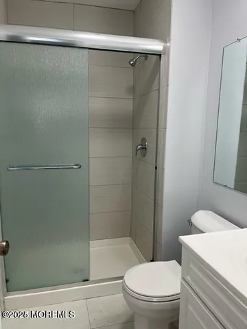 a white toilet sitting next to a bathroom