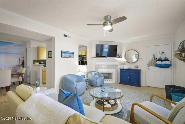 a living room with furniture kitchen view and a fireplace