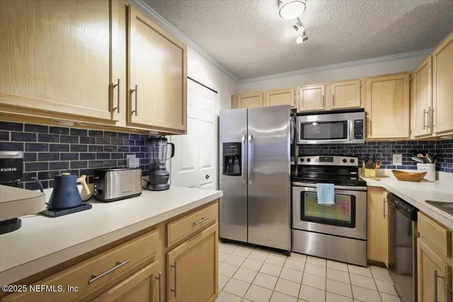 a kitchen with granite countertop a refrigerator and a sink
