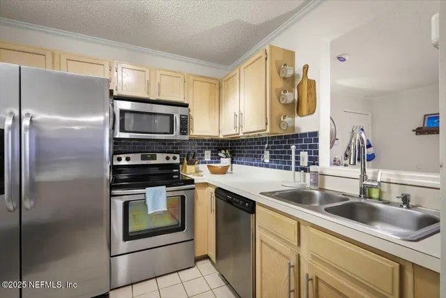 a kitchen with a sink stove and refrigerator