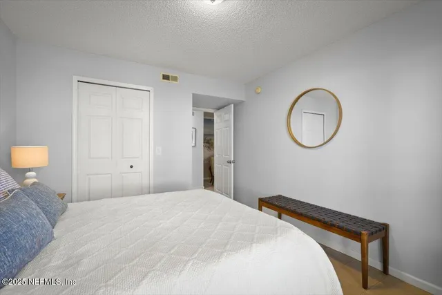 a bedroom with a bed and a chandelier