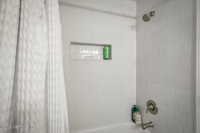 a bedroom with two beds and a large window