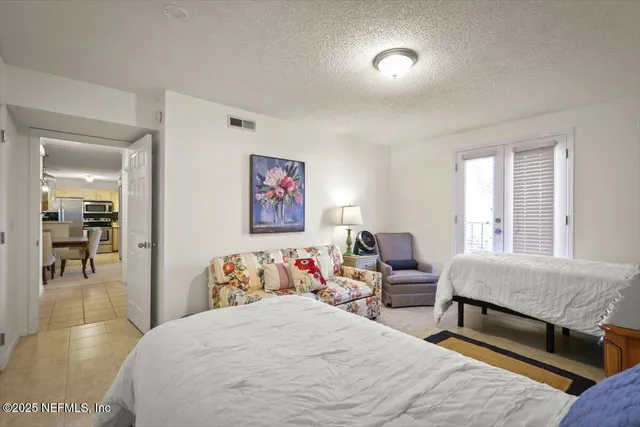 a bedroom with furniture and flat screen tv