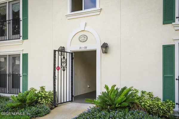 a front view of a house with plants