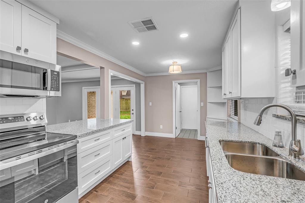 25703 Old Carriage Lane Spring, TX 77373 - Photo 17 of 25 Kitchen with plenty of lighting and airy look.