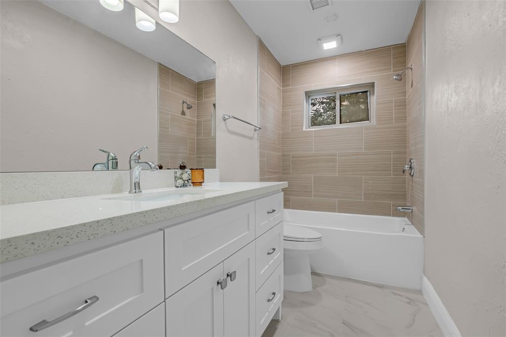 25703 Old Carriage Lane Spring, TX 77373 - Photo 19 of 25 This full bathroom features a contemporary vanity with a granite countertops and plenty of lighting.