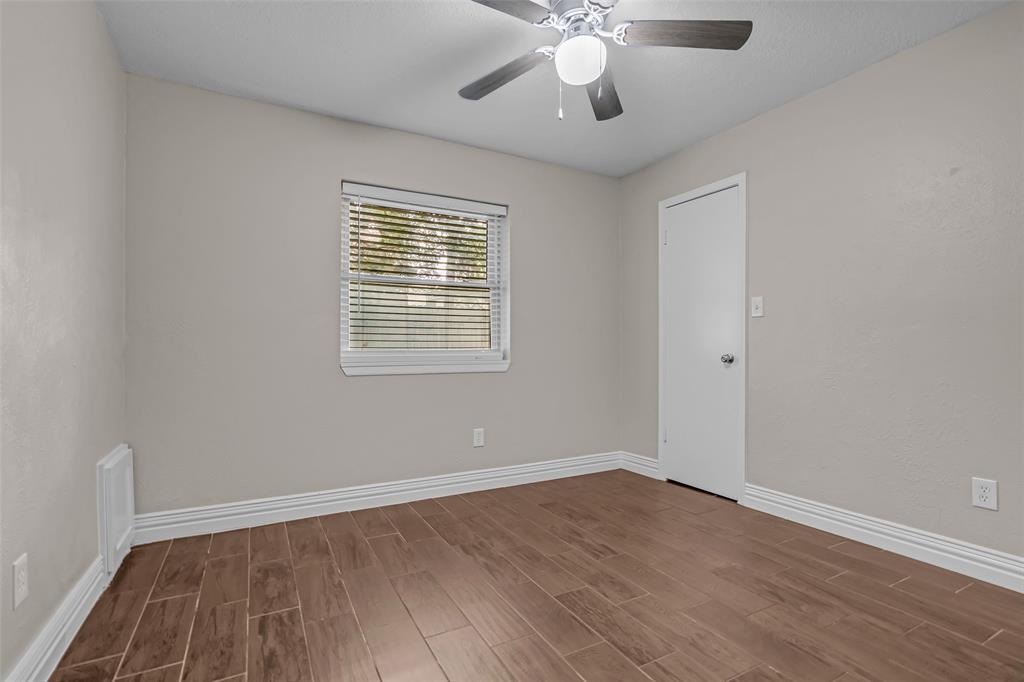 25703 Old Carriage Lane Spring, TX 77373 - Photo 20 of 25 Bedroom with walk-closet, window blinds and ceiling fan with overhead lighting.