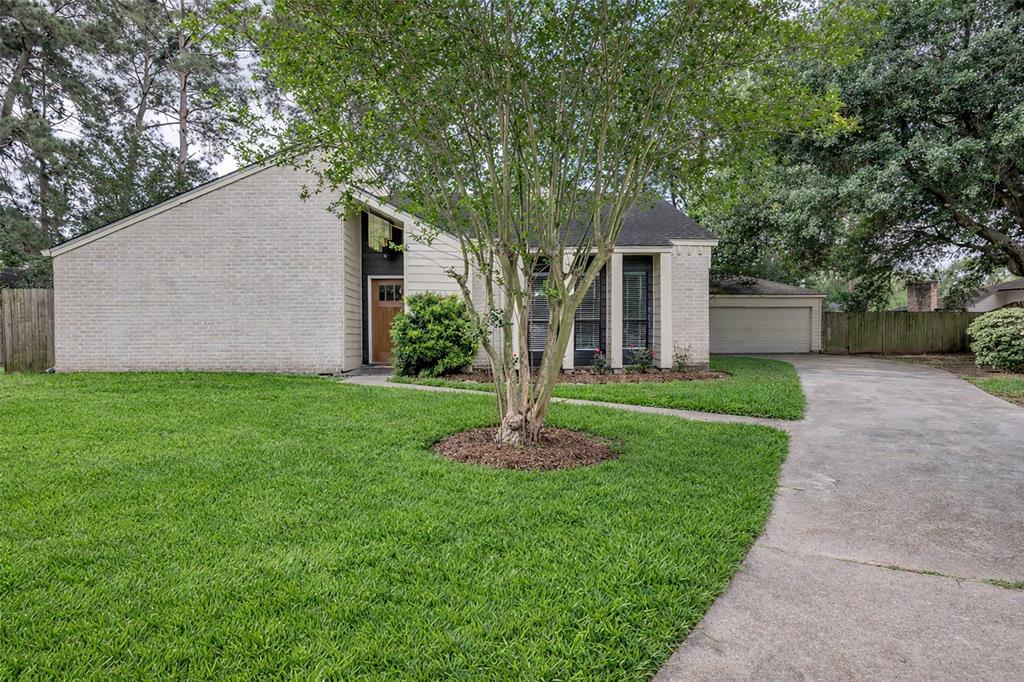 25703 Old Carriage Lane Spring, TX 77373 - Photo 2 of 25 Front facing driveway, and a light-colored brick exterior add to this homes charm.