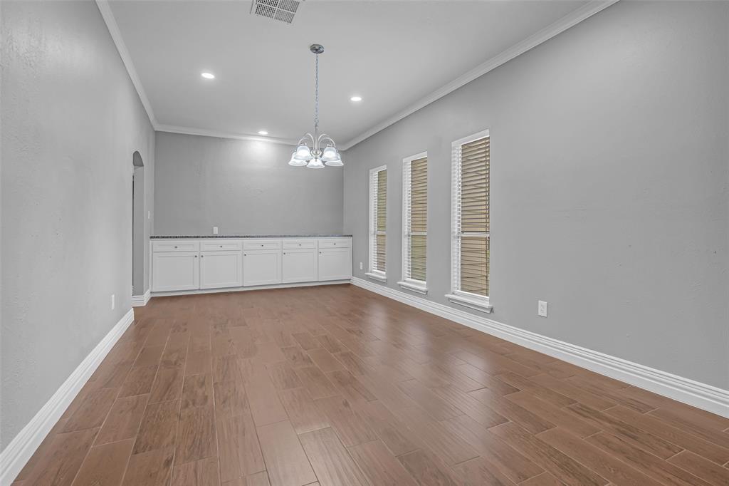 25703 Old Carriage Lane Spring, TX 77373 - Photo 3 of 25 Well lit large dining room featuring a built in buffet area with granite countertops and plenty of storage.