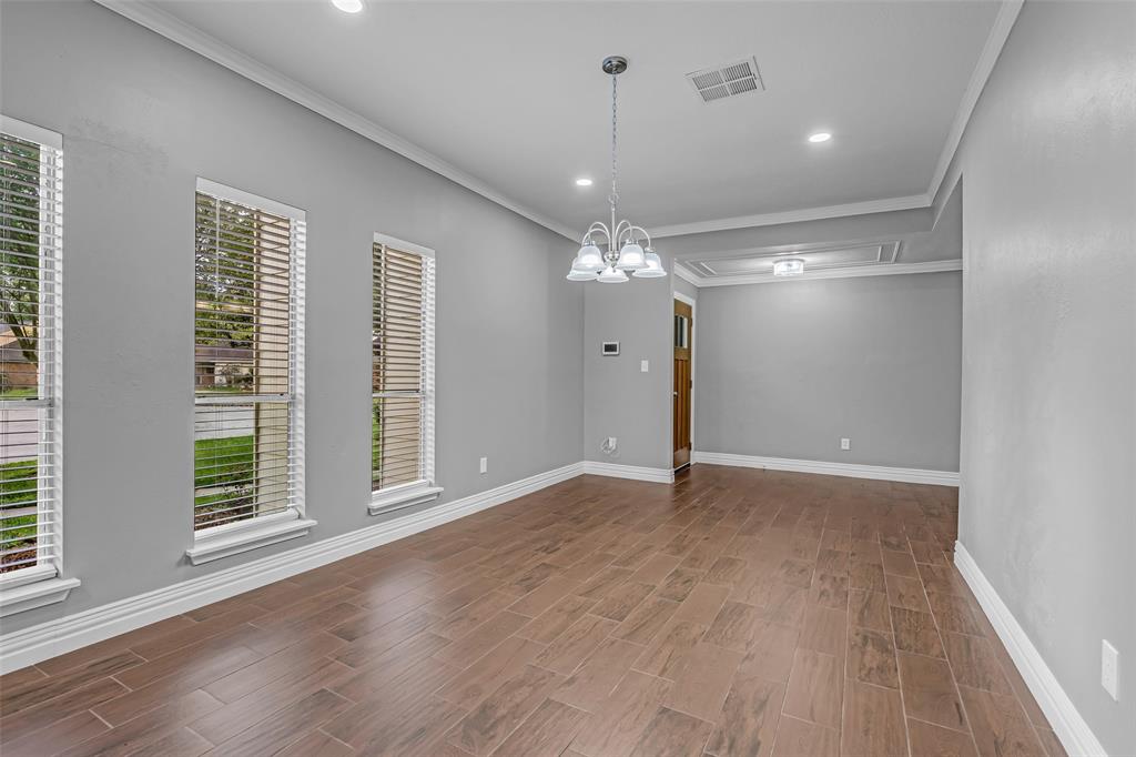 25703 Old Carriage Lane Spring, TX 77373 - Photo 5 of 25 This spacious dining room features large windows, neutral grey walls, and white crown molding give it a crisp look