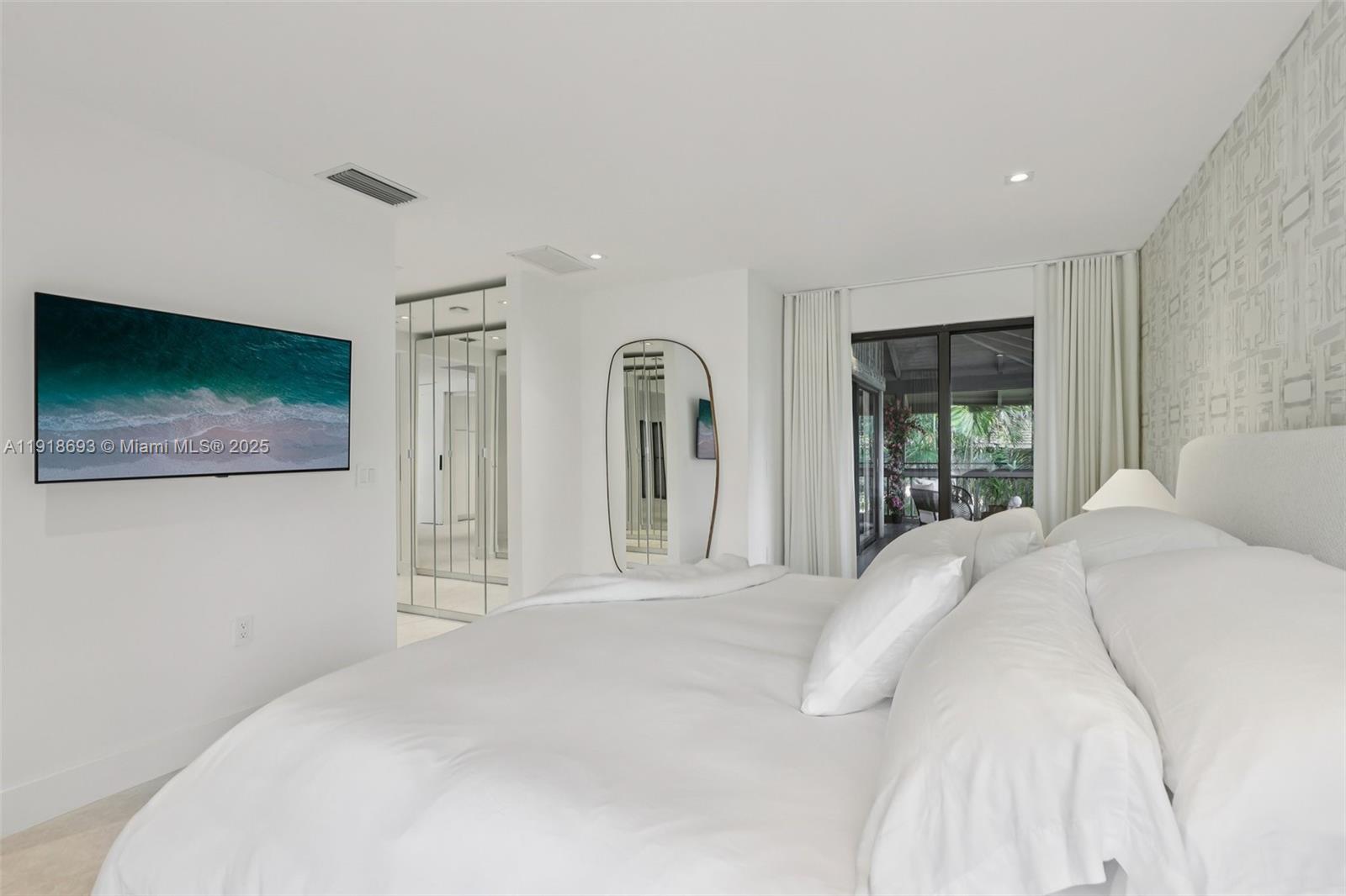 7123 Rain Forest Drive, Unit A Boca Raton, FL 33434 - Photo 24 of 75 a bedroom with a large bed and a flat screen tv