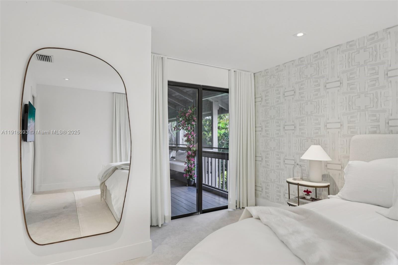 7123 Rain Forest Drive, Unit A Boca Raton, FL 33434 - Photo 28 of 75 a bedroom with a bed a mirror and glass door