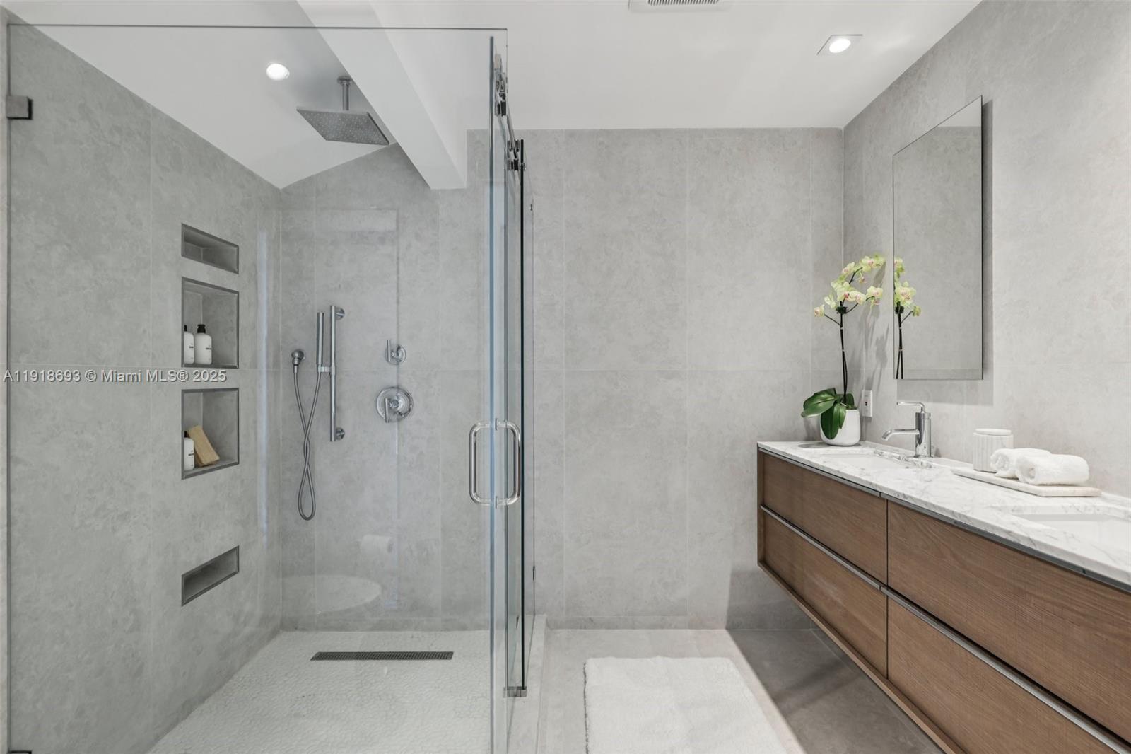 7123 Rain Forest Drive, Unit A Boca Raton, FL 33434 - Photo 31 of 75 a bathroom with a shower sink and mirror