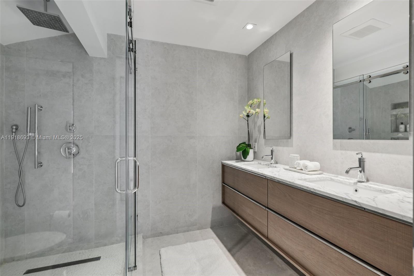 7123 Rain Forest Drive, Unit A Boca Raton, FL 33434 - Photo 32 of 75 a bathroom with a double vanity sink a mirror and a shower