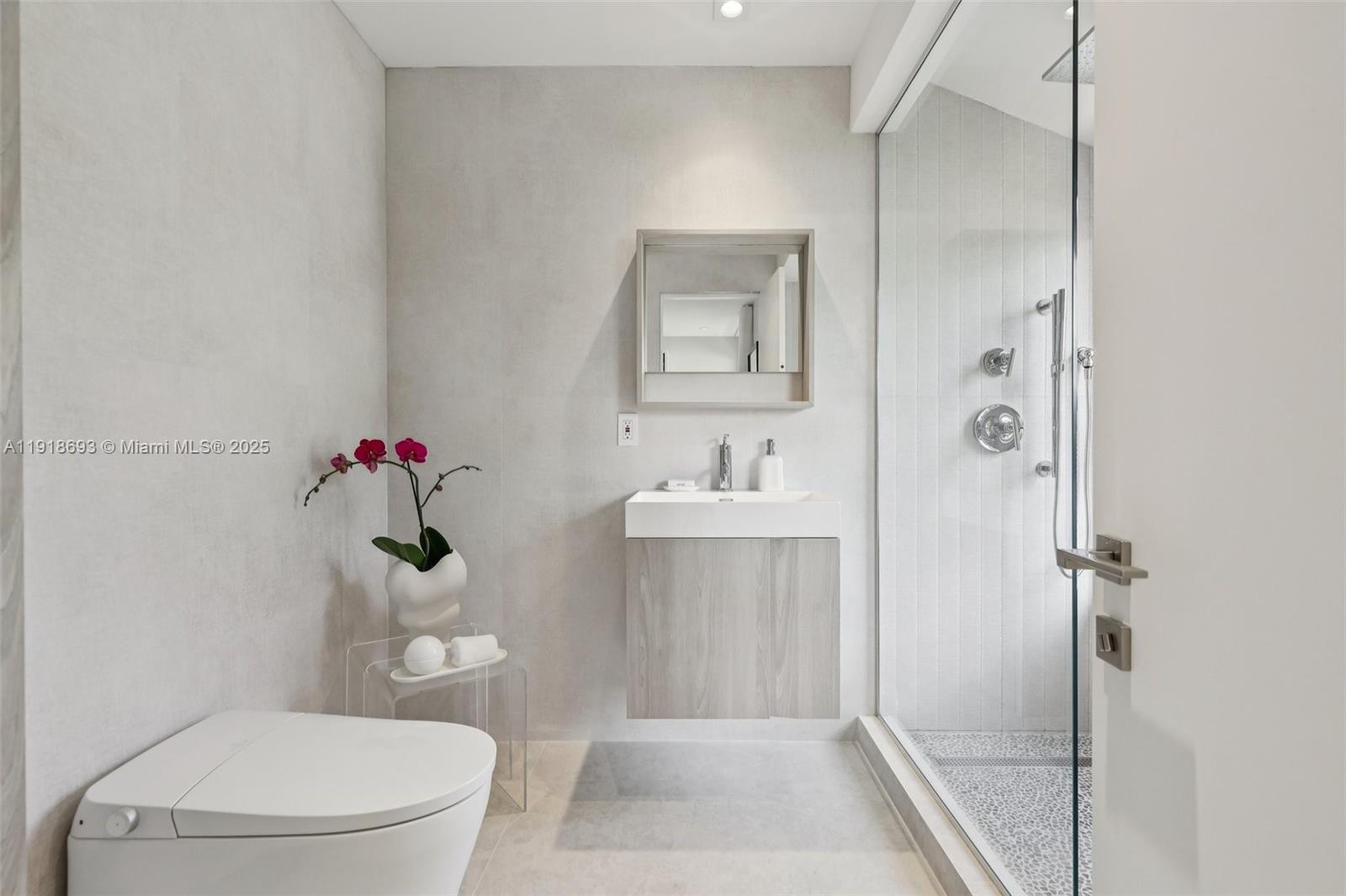 7123 Rain Forest Drive, Unit A Boca Raton, FL 33434 - Photo 44 of 75 a bathroom with a toilet sink and shower