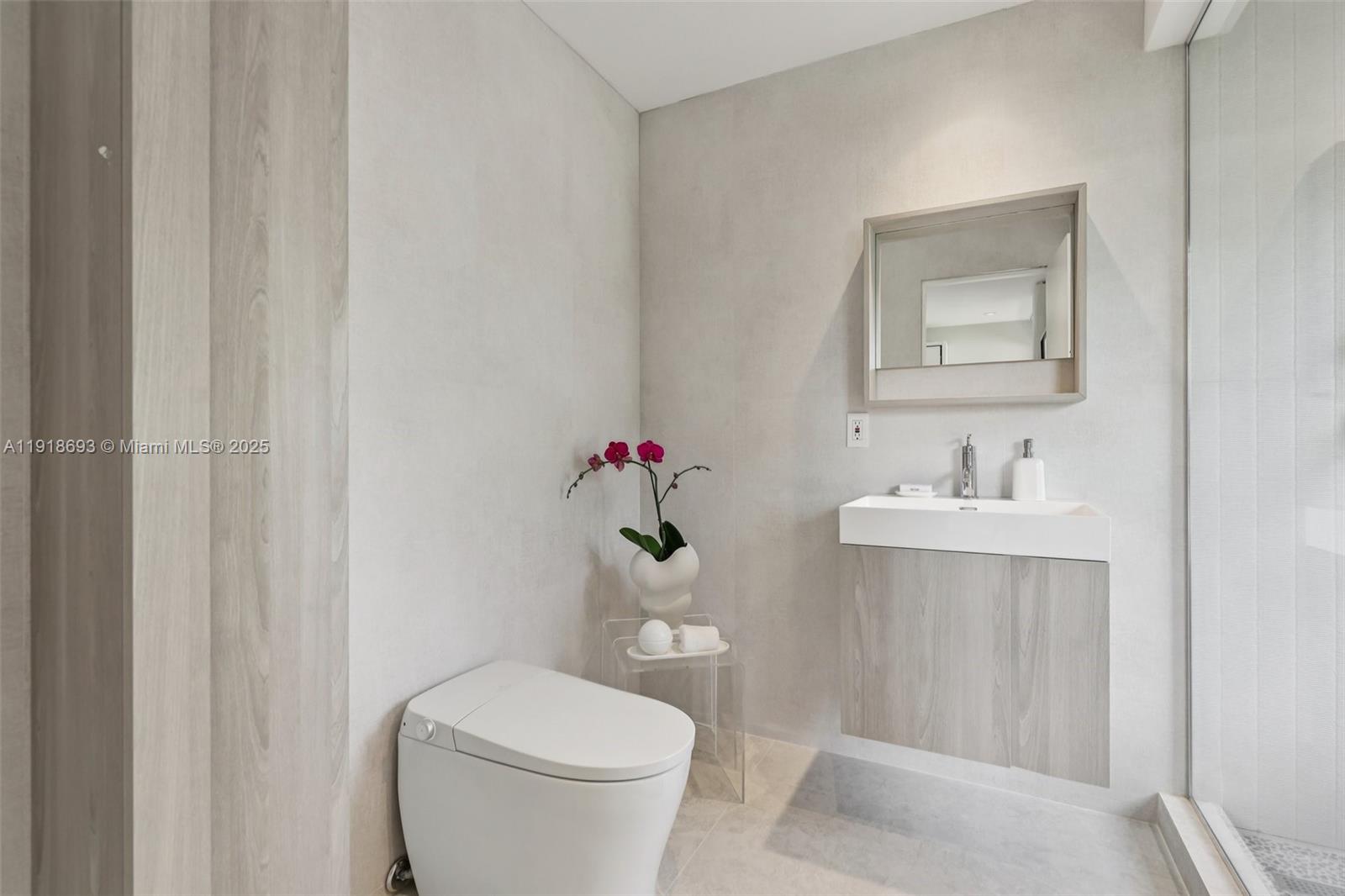 7123 Rain Forest Drive, Unit A Boca Raton, FL 33434 - Photo 45 of 75 a bathroom with a sink toilet and a mirror