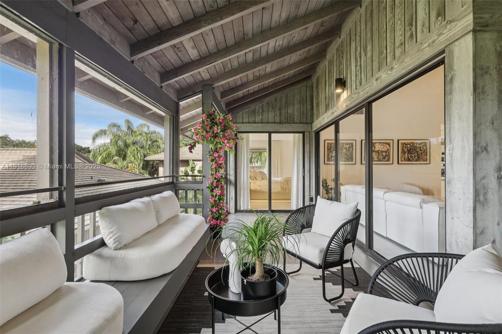 7123 Rain Forest Drive, Unit A Boca Raton, FL 33434 - Photo 54 of 75 a living room with furniture and a floor to ceiling window