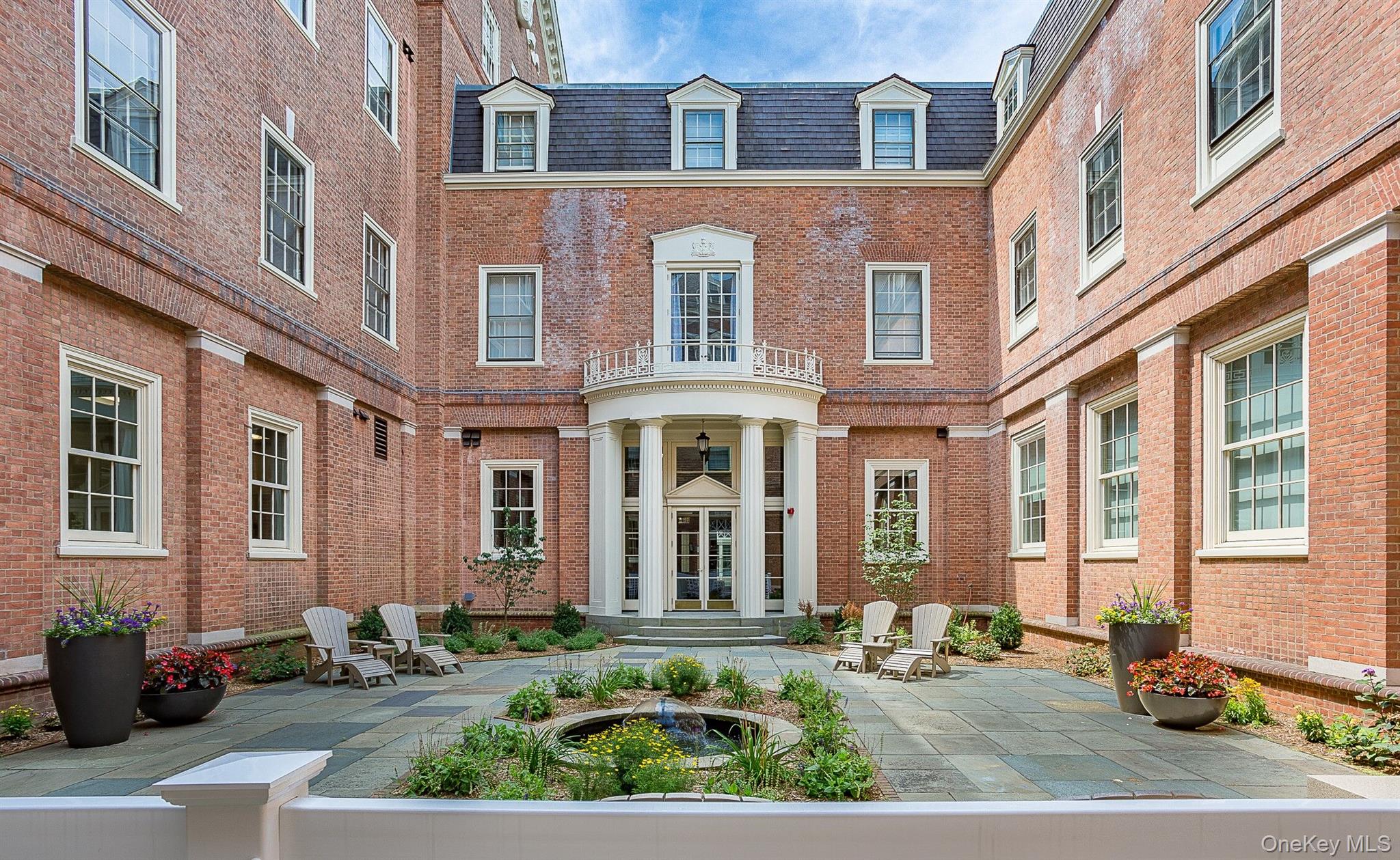 480 Bedford Road, Unit 401 Chappaqua, NY 10514 - Photo 6 of 12 Property entrance with brick siding and a patio area