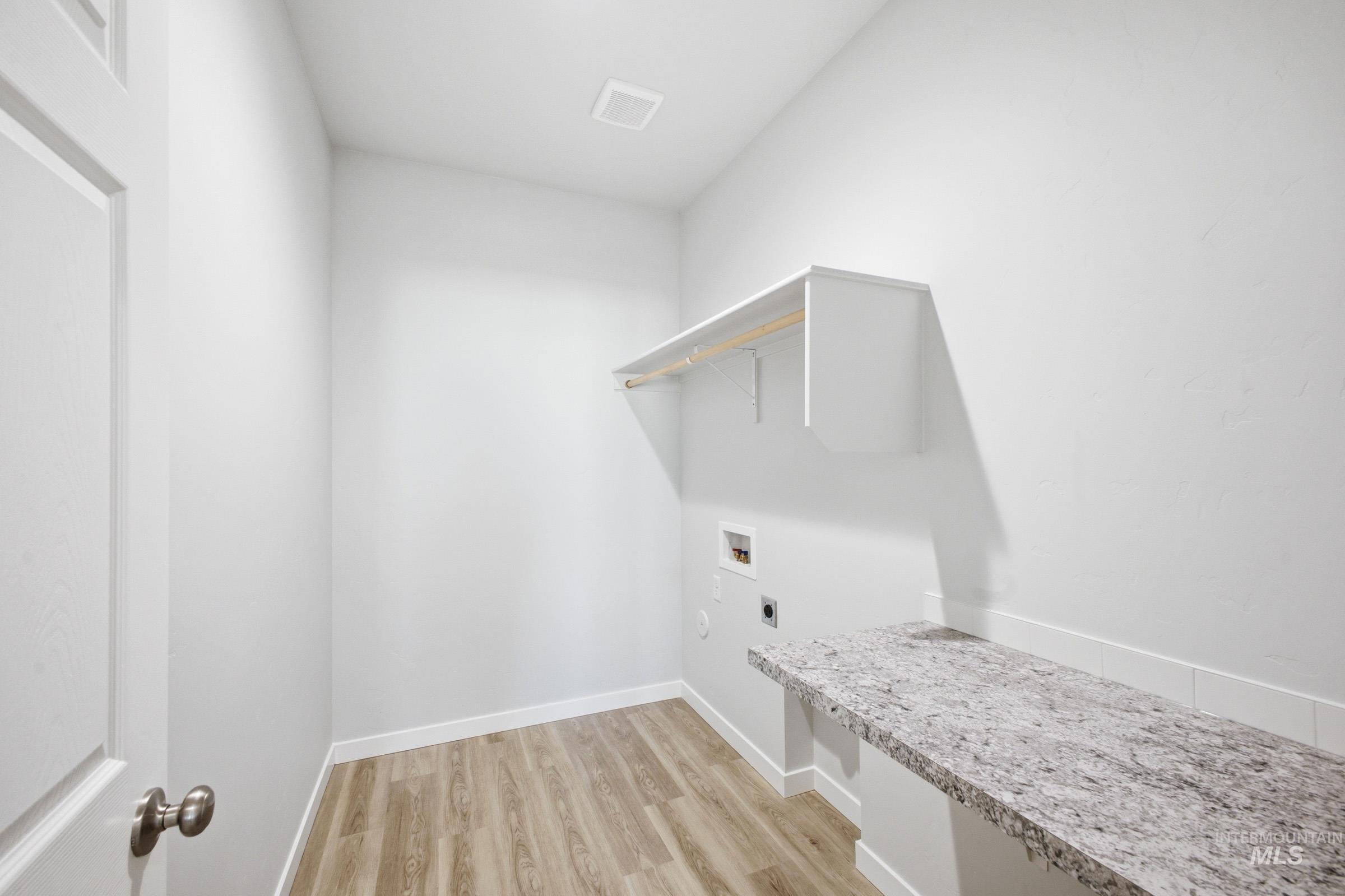 13633 Redway Court Caldwell, ID 83607 - Photo 13 of 29 Laundry area with light wood finished floors, washer hookup, and electric dryer hookup