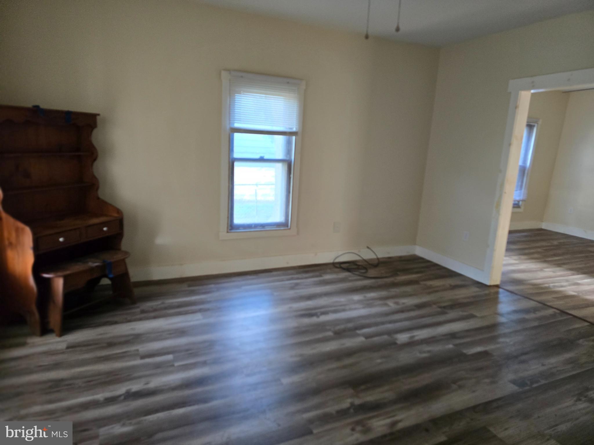 40 Maple Street Crisfield, MD 21817 - Photo 13 of 14 a view of a livingroom with wooden floor and a fireplace