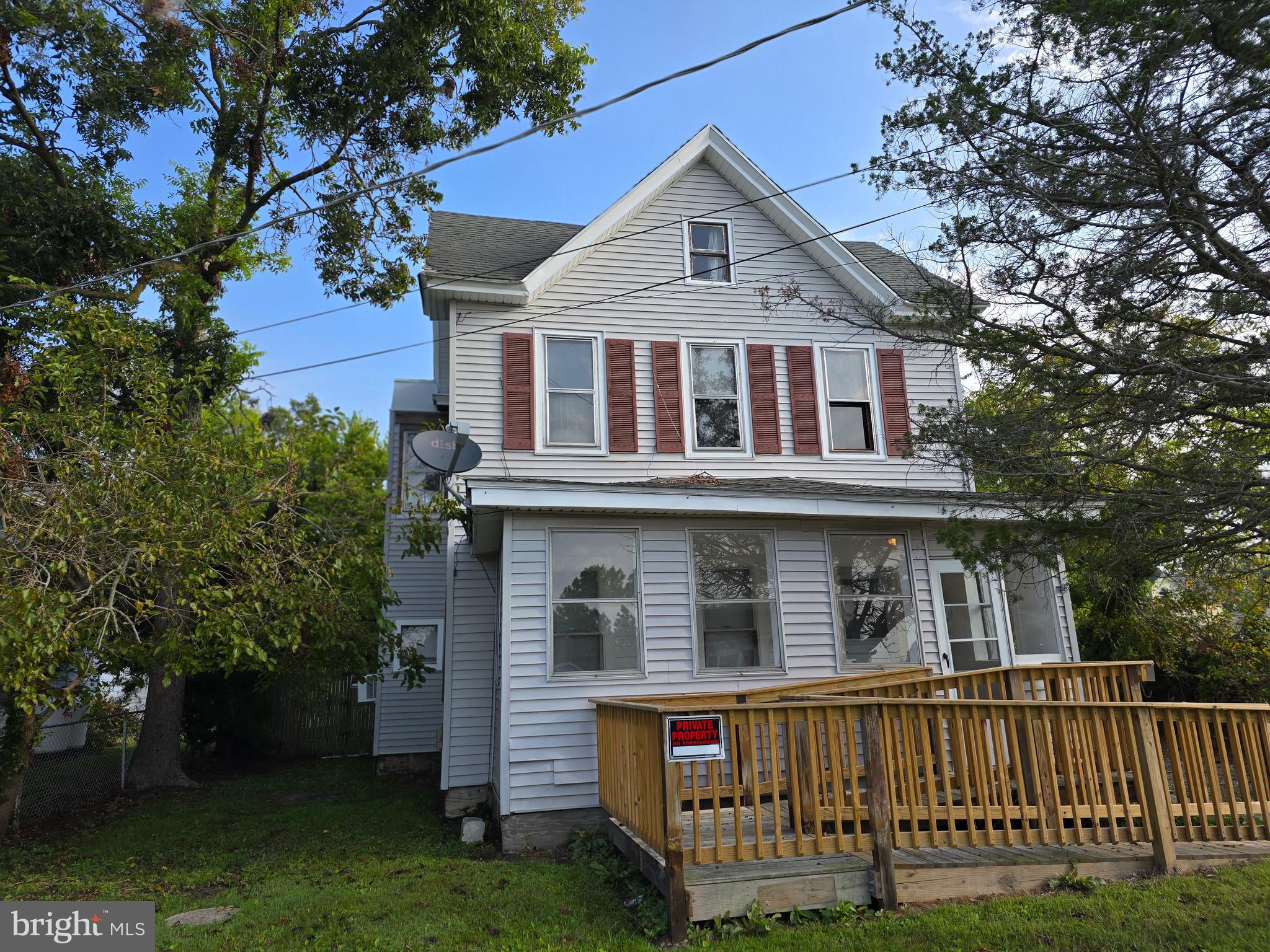 40 Maple Street Crisfield, MD 21817 - Photo 2 of 14 a front view of a house with a yard