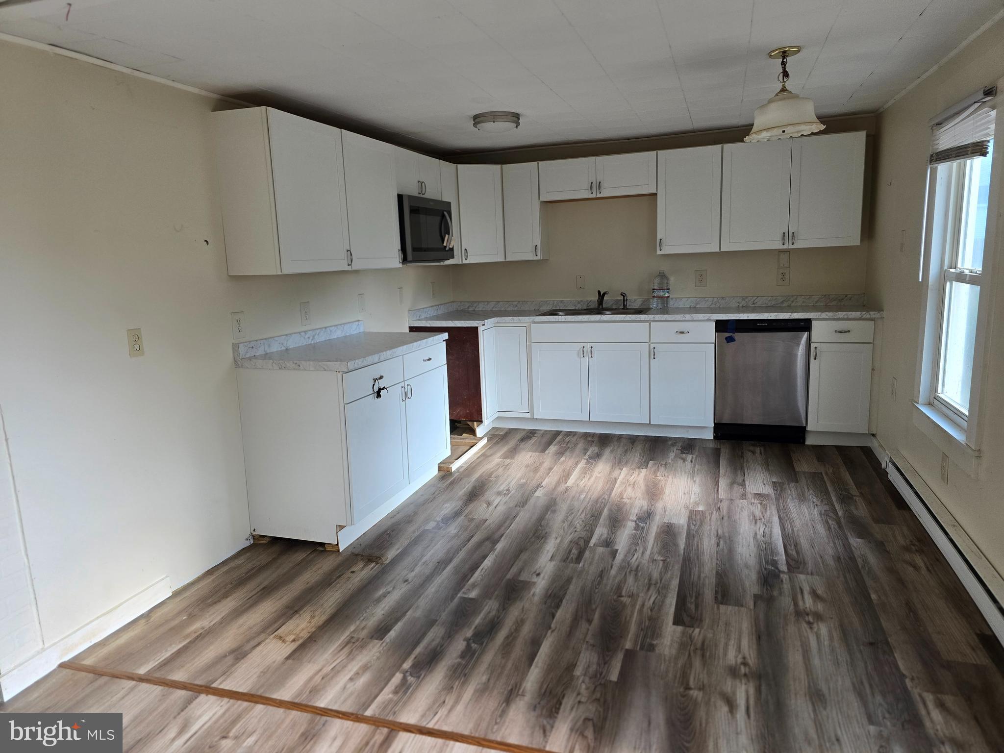 40 Maple Street Crisfield, MD 21817 - Photo 4 of 14 a kitchen with wooden floors and appliances