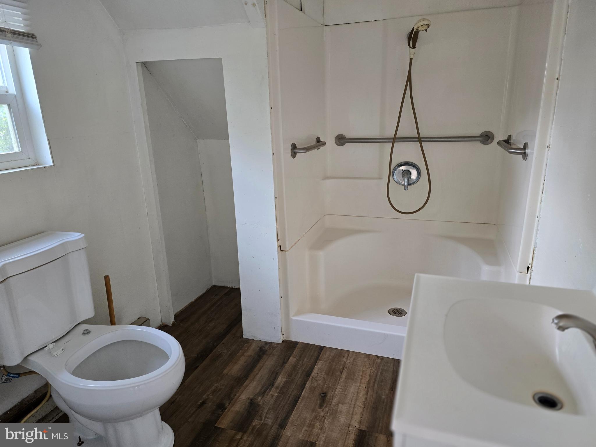 40 Maple Street Crisfield, MD 21817 - Photo 5 of 14 a bathroom with a granite countertop sink toilet and shower