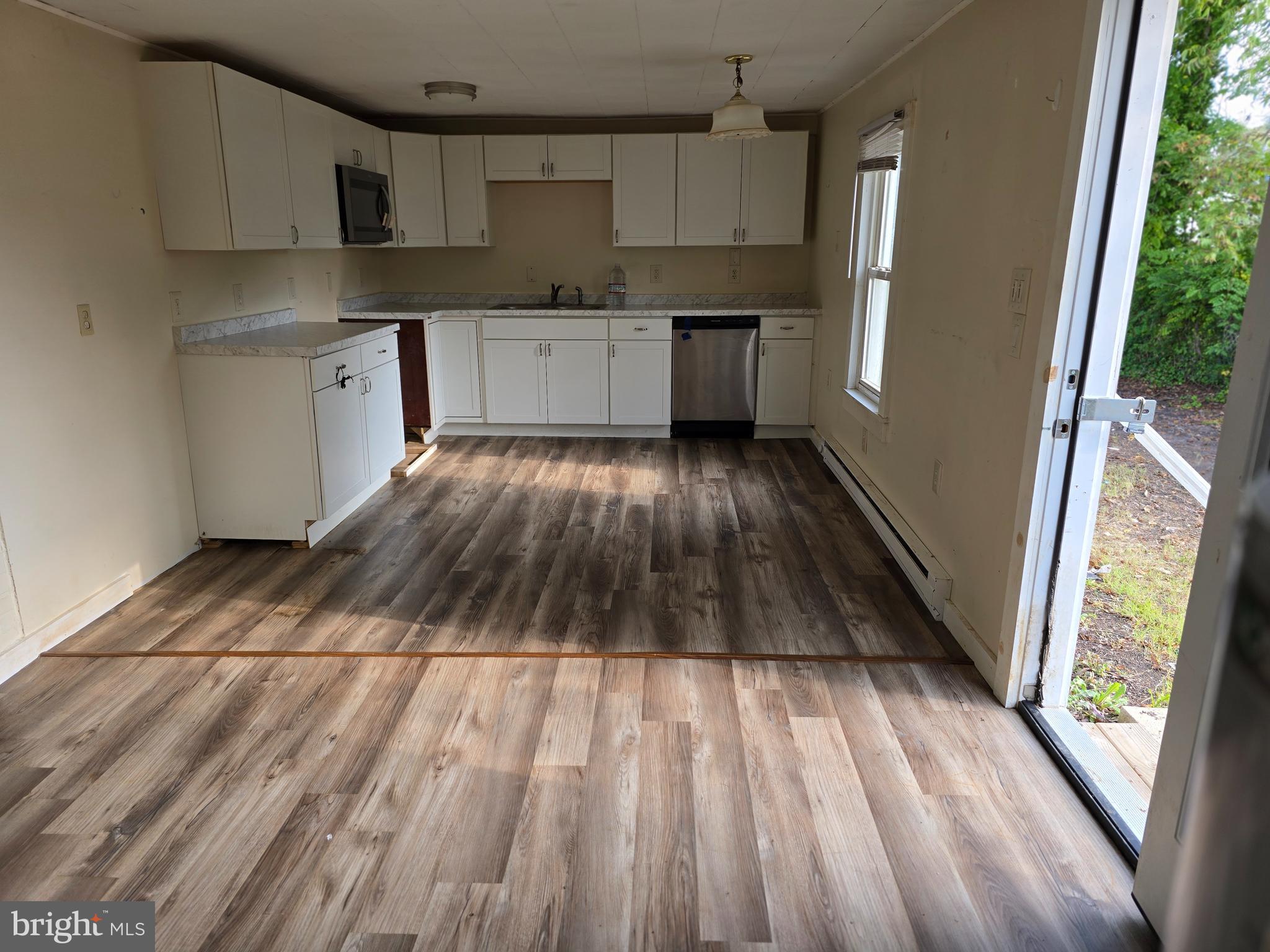 40 Maple Street Crisfield, MD 21817 - Photo 7 of 14 a kitchen with cabinets and wooden floor
