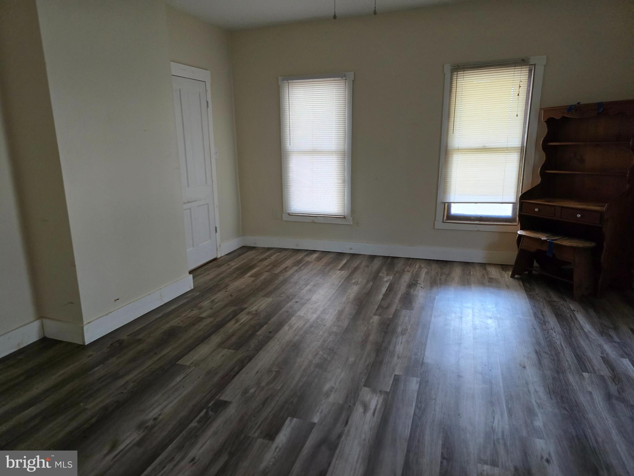 40 Maple Street Crisfield, MD 21817 - Photo 9 of 14 a view of empty room with wooden floor and fan